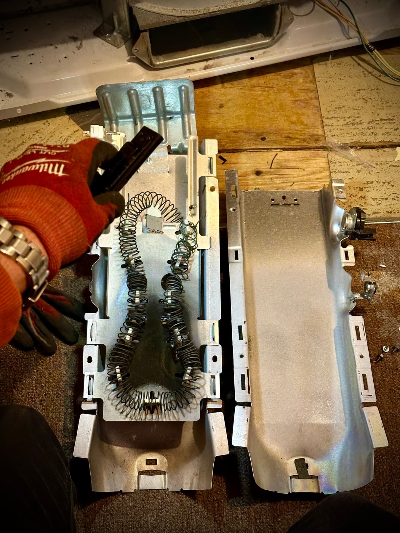 Technician repairing a dryer heating element