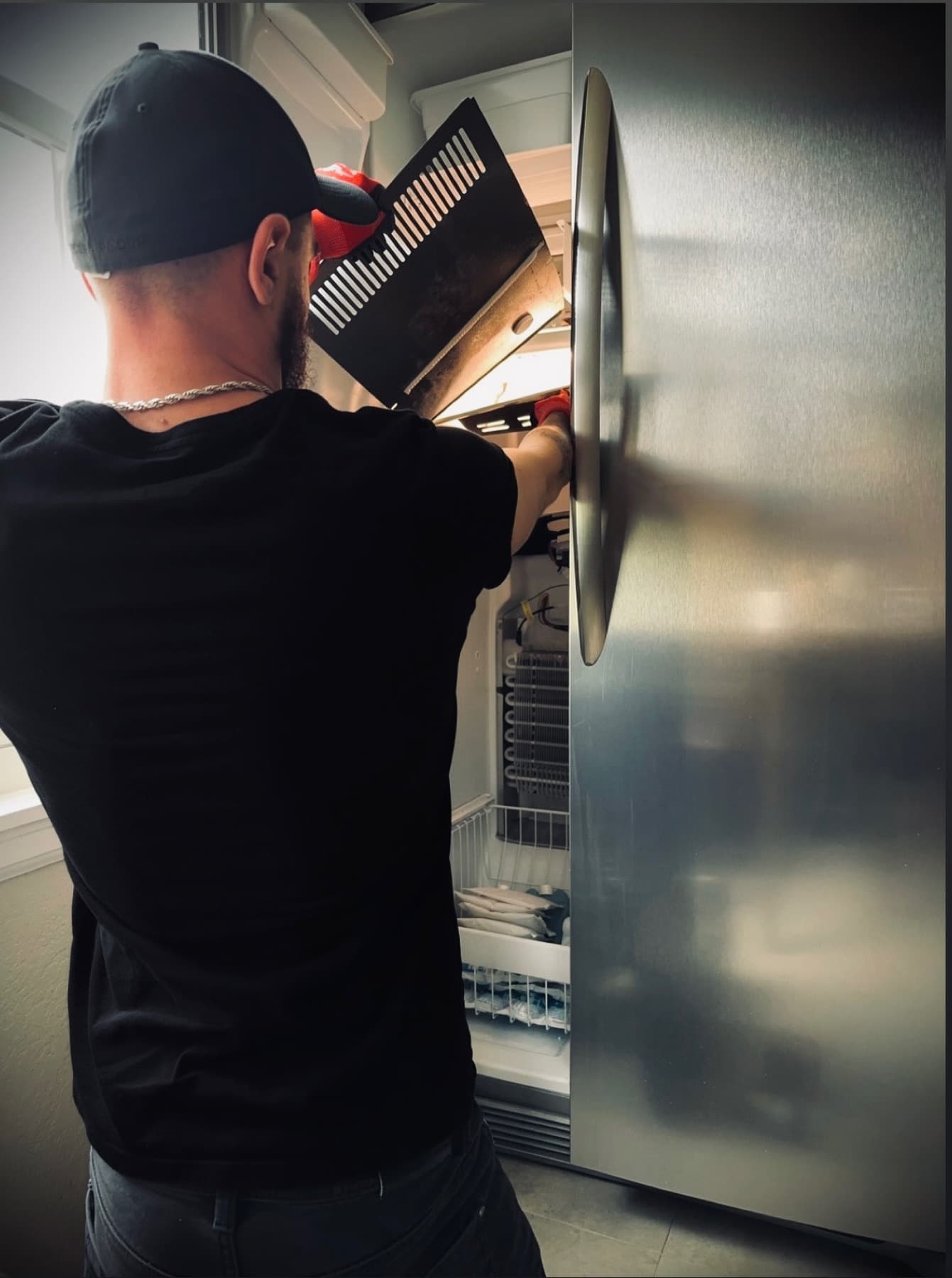 Denver's Best Appliance Repair technician working on a refrigerator